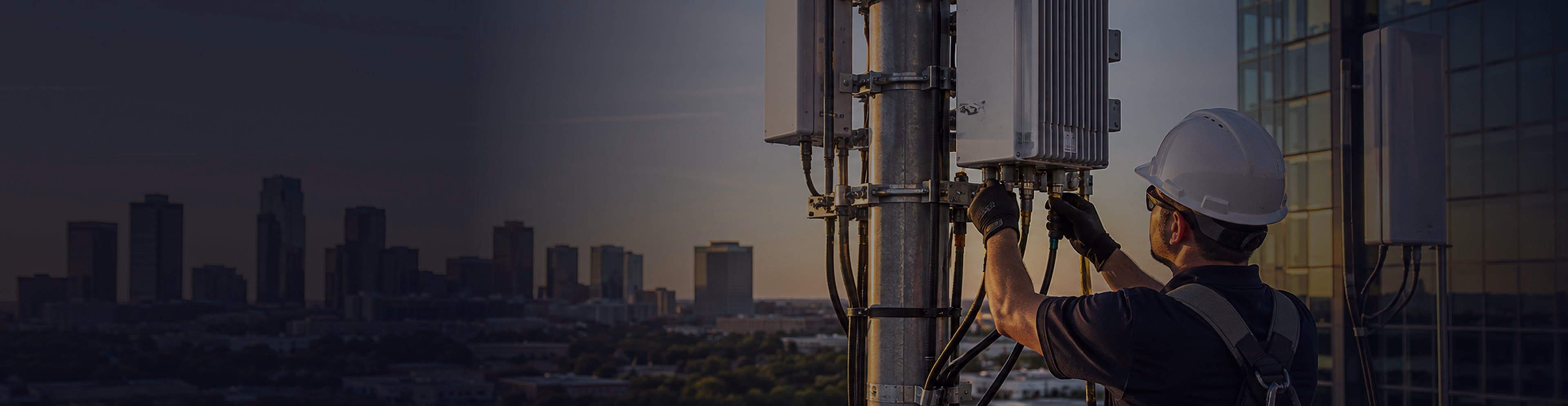 Technician working on rooftop radio antenna equipment
